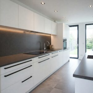 Contemporary kitchen design with long, sleek bar-style cabinet handles providing a modern aesthetic. modern kitchen cabinet hardware