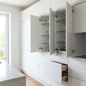 Open doors of frameless kitchen cabinets showcasing the full-overlay design and interior space.
