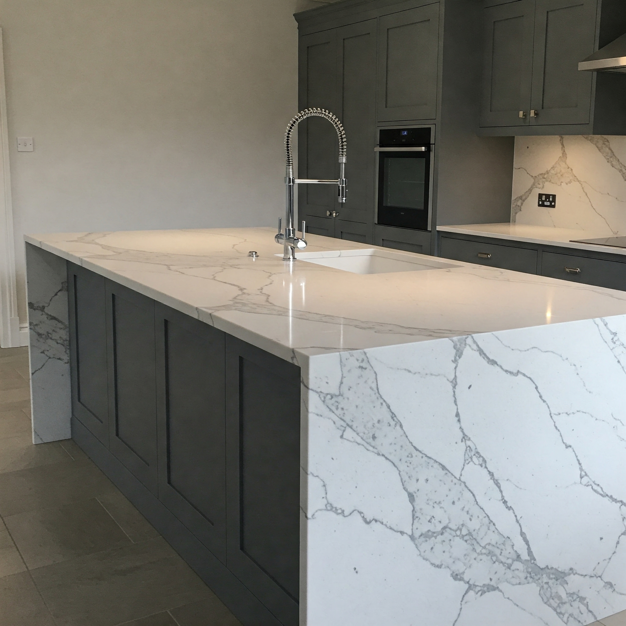 Elegant kitchen island with marble top design, a perfect centerpiece for modern kitchens.