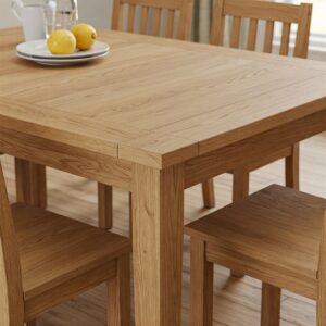 Natural wood grain detail on a farmhouse kitchen table and chairs.