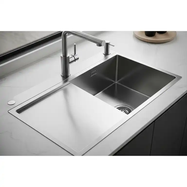 Modern stainless steel kitchen sink with drainboard, perfect for drying dishes.