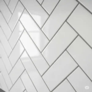 Close-up view of a classic white subway tile herringbone kitchen backsplash pattern.