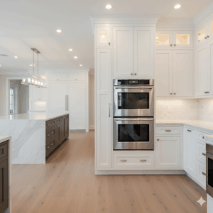 A high-end kitchen design featuring tall white kitchen cabinets with stainless appliances and a double stainless steel wall oven, perfect for a modern home.