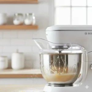 The plastic splatter guard successfully keeping flour inside the bowl of the Bosch mixer while beating eggs. 