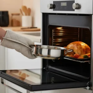 Demonstrating the versatility of an oven-safe 3 qt saute pan moving from stovetop to oven.