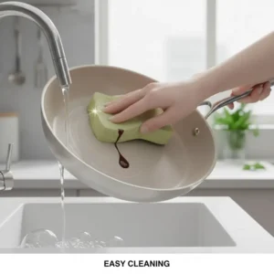 A person easily wiping clean the non-stick surface of ceramic coated stainless steel cookware.