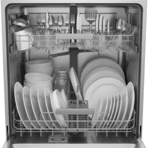 Interior view of an oversized dishwasher fully loaded with large dinner plates and serving platters.