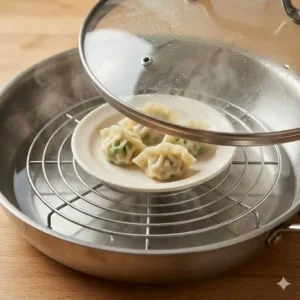 An alternative way to steam food without a steamer by placing a round wire baking rack inside a deep skillet with water.